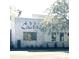 Commercial building with a grey brick facade and stylish signage in front of a grassy area at 182 E Pinckney St, Lincolnville, SC 29485
