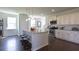 Spacious kitchen featuring white cabinets, stainless steel appliances, and a granite countertop kitchen island at 182 E Pinckney St, Lincolnville, SC 29485