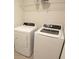 The laundry room contains modern, white appliances at 182 E Pinckney St, Lincolnville, SC 29485