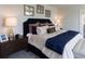 This main bedroom has a padded headboard, a dresser, and neutral decor at 182 E Pinckney St, Lincolnville, SC 29485