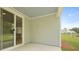 Covered patio with backyard pond view through the glass door at 182 E Pinckney St, Lincolnville, SC 29485