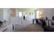 An upstairs living area featuring neutral walls, carpeted floors, and space for multiple activities at 182 E Pinckney St, Lincolnville, SC 29485