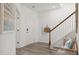 Inviting entryway with neutral tones, wood-look flooring, a bench, a staircase and tasteful decorations at 1827 Nola Run, Summerville, SC 29485