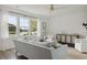 Bright and airy living room with water views from the large windows, neutral-toned decor, and modern furnishings at 1827 Nola Run, Summerville, SC 29485