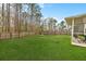 Expansive backyard featuring a well-maintained lawn, a wooden fence, and a patio area at 184 Charlesfort Way, Moncks Corner, SC 29461