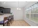 Cozy breakfast nook features a window, a chandelier, tile flooring, and barstool seating at 184 Charlesfort Way, Moncks Corner, SC 29461
