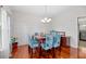 Bright dining room with hardwood floors features a chandelier, decorative chair coverings, and a plant at 184 Charlesfort Way, Moncks Corner, SC 29461