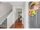 Inviting entryway features hardwood floors, staircase, and a decorative wreath on the front door at 184 Charlesfort Way, Moncks Corner, SC 29461