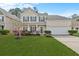 Charming two-story home featuring a well-manicured lawn and beautiful landscaping at 184 Charlesfort Way, Moncks Corner, SC 29461