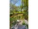 Aerial view of a private, immaculately landscaped backyard with a water fountain and outdoor dining at 184 Tradd St, Charleston, SC 29401