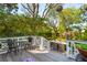 Inviting backyard deck with outdoor seating overlooks lush landscaping and a picturesque garden setting at 184 Tradd St, Charleston, SC 29401