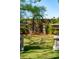 Elegant backyard featuring decorative statues and urns set amidst lush landscaping and mature trees at 184 Tradd St, Charleston, SC 29401