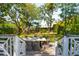Beautifully landscaped backyard featuring a spacious patio with dining set, surrounded by greenery and charming details at 184 Tradd St, Charleston, SC 29401