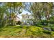 Spacious backyard showcasing an outdoor patio with dining set, lush lawn, and a charming home exterior at 184 Tradd St, Charleston, SC 29401