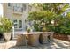 Outdoor dining area with stylish patio and chairs, complemented by well-maintained landscaping and the home's exterior at 184 Tradd St, Charleston, SC 29401
