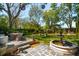 Expansive backyard with a stone patio, dining set, fountain and lush landscaping creating a serene outdoor retreat at 184 Tradd St, Charleston, SC 29401