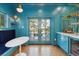 Stylish bar with a wine fridge, booth seating, and blue cabinets at 184 Tradd St, Charleston, SC 29401