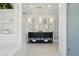 Bright bathroom featuring a soaking tub with marble surround, double vanity, and luxurious finishes at 184 Tradd St, Charleston, SC 29401