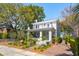 Charming two-story home with a welcoming front porch, manicured landscaping, and a brick driveway at 184 Tradd St, Charleston, SC 29401
