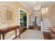 Elegant foyer with hardwood floors, decorative mirror, chandelier, and staircase at 184 Tradd St, Charleston, SC 29401