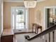 Inviting foyer with a glass front door, staircase, and traditional decor at 184 Tradd St, Charleston, SC 29401