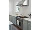 Close-up of a stainless steel range and hood in a kitchen with white subway tile at 184 Tradd St, Charleston, SC 29401