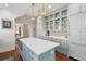 Bright kitchen featuring white subway tile, custom cabinetry, and a center island at 184 Tradd St, Charleston, SC 29401