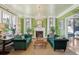 Bright living room with green walls, fireplace, chandelier, and comfortable seating at 184 Tradd St, Charleston, SC 29401