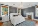 Bedroom featuring a fireplace, chandelier, neutral tones, and hardwood floors at 184 Tradd St, Charleston, SC 29401