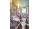 Cozy powder room featuring floral wallpaper, a vessel sink, and gold fixtures at 184 Tradd St, Charleston, SC 29401