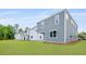 A green lawn and backyard shows a gray, two-story home with classic siding and white trim at 194 E Pinckney St, Lincolnville, SC 29485
