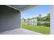 Scenic backyard view with lush green lawn and pond reflecting nearby homes under a clear blue sky at 194 E Pinckney St, Lincolnville, SC 29485