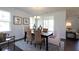 Bright dining area with a modern chandelier, stylish furnishings, and natural light at 194 E Pinckney St, Lincolnville, SC 29485