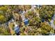 Overhead view of the property highlighting the home's roof and driveway within a wooded setting at 2107 Nicholas David Path, Johns Island, SC 29455