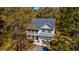 Captivating aerial view of the home with a cozy front porch, lush landscaping, and a private driveway at 2107 Nicholas David Path, Johns Island, SC 29455
