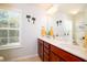 Well-lit bathroom featuring a double vanity and decorative palm tree accents at 2107 Nicholas David Path, Johns Island, SC 29455