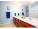 Bright bathroom featuring a double vanity with white countertops and blue walls at 2107 Nicholas David Path, Johns Island, SC 29455