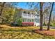 Inviting two-story home with a charming porch, manicured lawn, and mature landscaping, perfect for serene outdoor living at 2107 Nicholas David Path, Johns Island, SC 29455