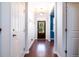 Hallway with hardwood floors leading to a front door with glass panes and lots of natural light at 2107 Nicholas David Path, Johns Island, SC 29455