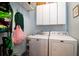 Bright laundry room with front-load washer and dryer, storage cabinets, and laundry accessories at 2107 Nicholas David Path, Johns Island, SC 29455