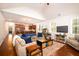 Open-concept living space with a cozy seating area, hardwood floors, and seamless flow to the kitchen at 2107 Nicholas David Path, Johns Island, SC 29455