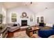 Cozy living room with a fireplace, hardwood floors, and neutral colored furniture at 2107 Nicholas David Path, Johns Island, SC 29455