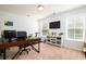 A home office is decorated with a large desk, monitors, book shelf, and exercise bike at 2107 Nicholas David Path, Johns Island, SC 29455