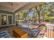 A screened-in porch boasts wicker furniture, a ceiling fan, and a view of the backyard at 2107 Nicholas David Path, Johns Island, SC 29455