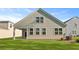 Backyard showing the home's siding and well-maintained lawn at 2179 Macallan Blvd, Ravenel, SC 29470