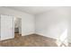A modern bedroom with hardwood floors and door that leads to the bathroom at 2179 Macallan Blvd, Ravenel, SC 29470