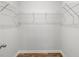 A walk-in closet with metal shelving and wood flooring at 2179 Macallan Blvd, Ravenel, SC 29470