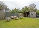 Landscaped backyard with patio furniture, a wooden fence and a shed at 223 Grove St, Charleston, SC 29403