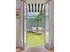 Backyard patio with furniture set, through french doors with striped awning at 223 Grove St, Charleston, SC 29403