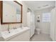 Bright bathroom featuring a double sink vanity, white tile floor, and updated fixtures at 223 Grove St, Charleston, SC 29403